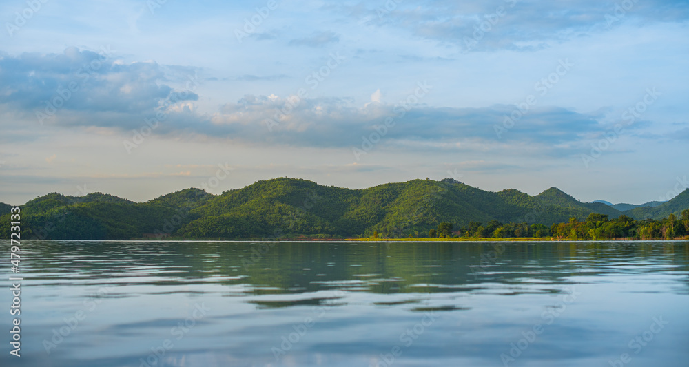 lake and mountain on background in the morning time. natural landscape in Kanchanaburi province, Thailand at summer time so warm and relax after lockdown covid19.
