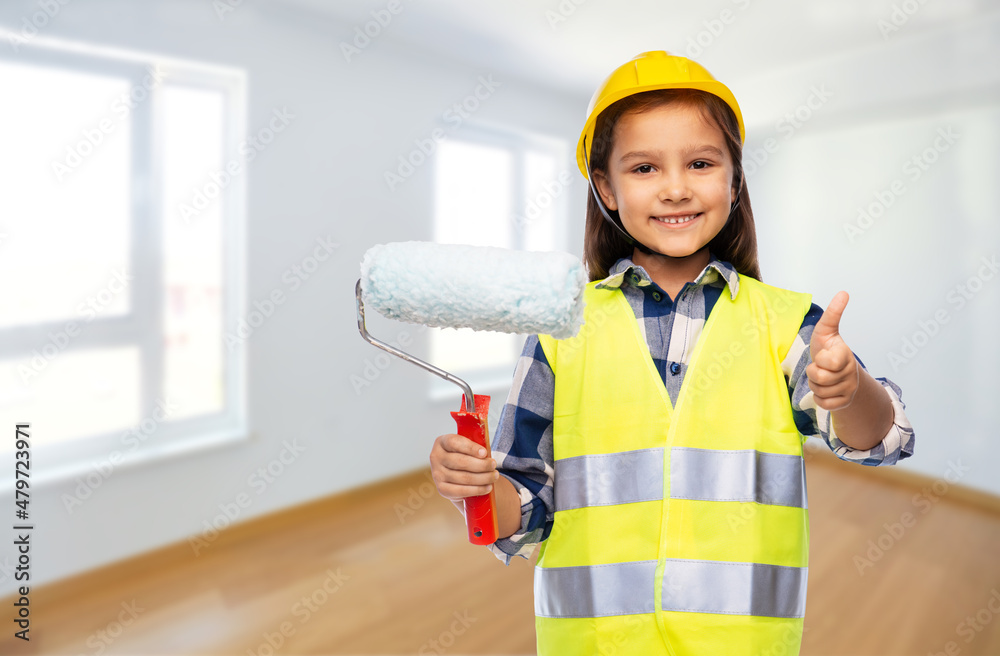 building, construction and profession concept - smiling little girl in protective helmet and safety vest with paint roller showing thumbs up over empty room on background building, construction and profession concept - smiling little girl in protective helmet and safety vest with paint roller showing thumbs up over empty room on background