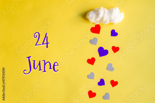 24 june day of month, colorful hearts rain from a white cotton cloud on a yellow background. Valentine's day, love and wedding concept