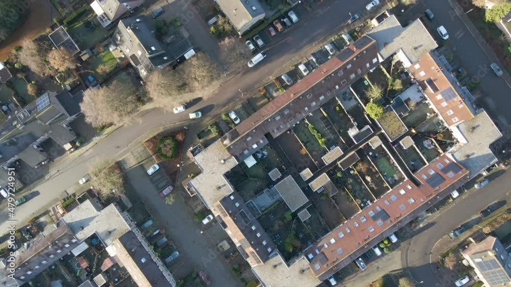 Top down aerial of a beautiful suburban area with a single car driving over road Top down aerial of a beautiful suburban area with a single car driving over road