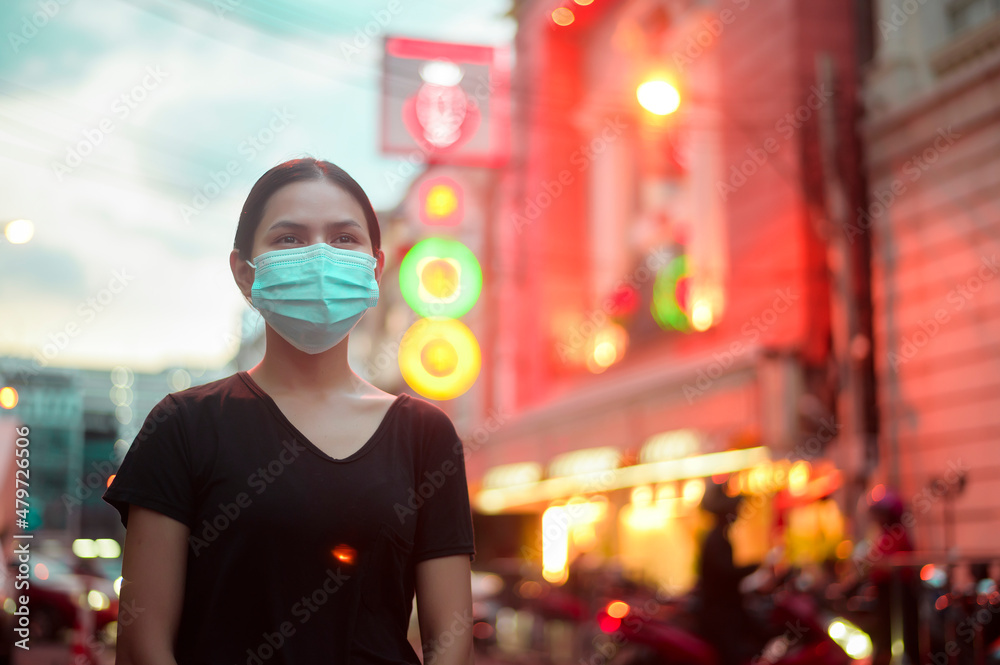 Beautiful woman wearing a surgical mask outdoor, covid-19 , health and pollution concept..