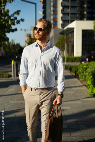 Young stylish businessman. Portrait of handsome man outdoors..