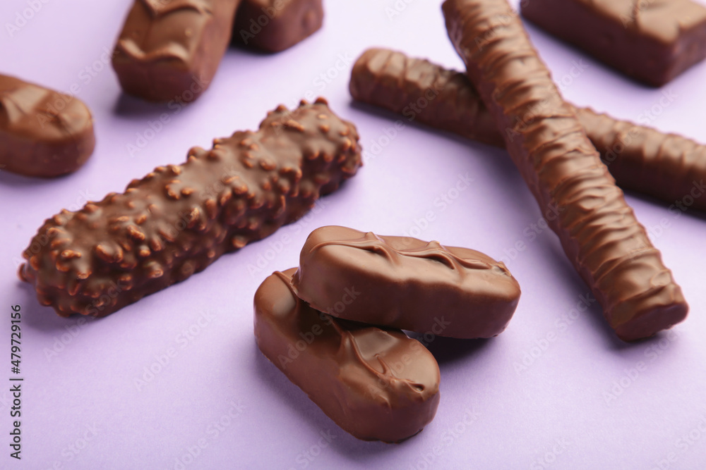 Mix of chocolate bars on purple background with copy space. Top view. Mix of chocolate bars on purple background with copy space. Top view.