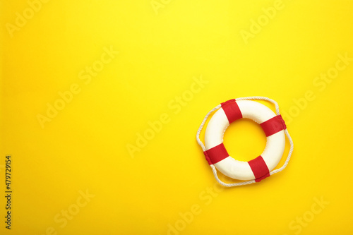 Lifebuoy on yellow background with copy space