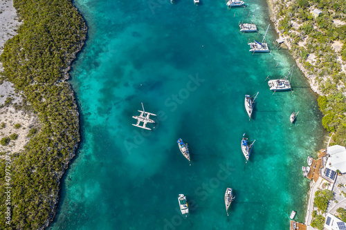 Aerial view of anchored sailing yacht in emerald Caribbean sea, Stocking Island, Great Exuma, Bahamas. © yujie