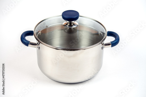 Metal saucepan with a glass lid for cooking soup, food. made of stainless steel. kitchen utensils with a thick bottom for electric, infrared, induction or gas stoves. On an isolated white background
