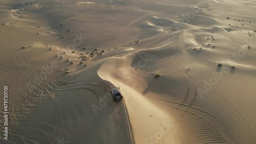 4K: Drone tracking the  4x4 during the desert safari in the Al Qudra desert of Dubai, United Arab Emirates photo