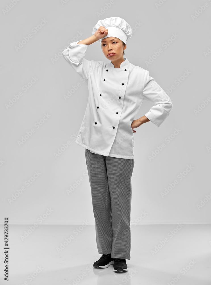 cooking, culinary and people concept - tired female chef in white jacket over grey background cooking, culinary and people concept - tired female chef in white jacket over grey background