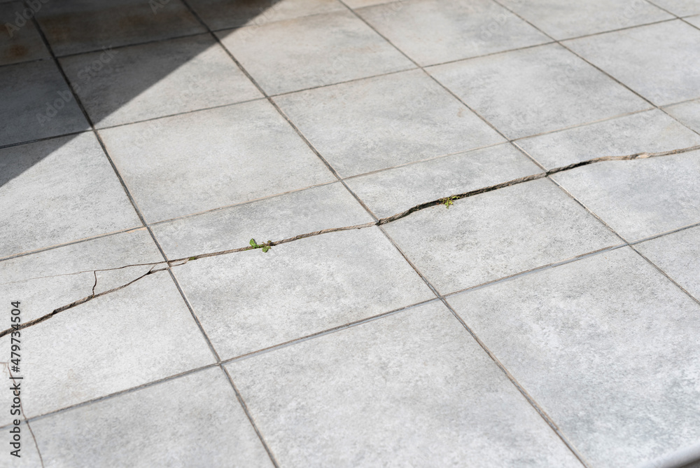 Fototapeta premium Old and broken cracked outdoor concrete floor tiles