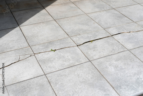 Old and broken cracked outdoor concrete floor tiles