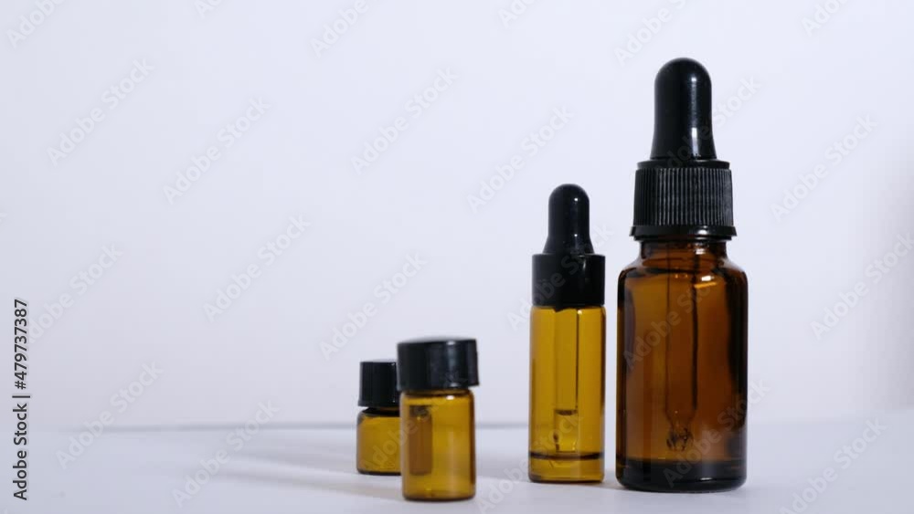 Different empty bottles of essential oils rotate 180 degrees on a white background. High quality 4k footage Different empty bottles of essential oils rotate 180 degrees on a white background. High quality 4k footage