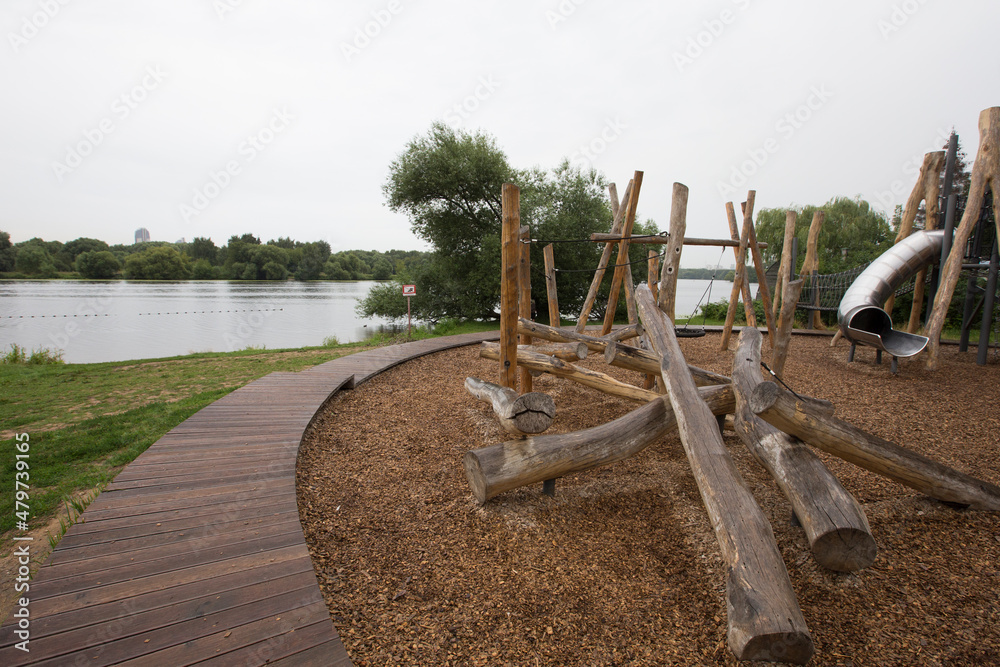 children's playground made of environment, eco-friendly materials. Wooden tree trunk sides, swings, net bridges, climbers. Beach number 2, Serebryany Bor (Silver Pinewood) forest park. Moscow, Russia children's playground made of environment, eco-friendly materials. Wooden tree trunk sides, swings, net bridges, climbers. Beach number 2, Serebryany Bor (Silver Pinewood) forest park. Moscow, Russia