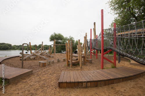 children's playground made of environment, eco-friendly materials. Wooden tree trunk sides, swings, net bridges, climbers. Beach number 2, Serebryany Bor (Silver Pinewood) forest park. Moscow, Russia