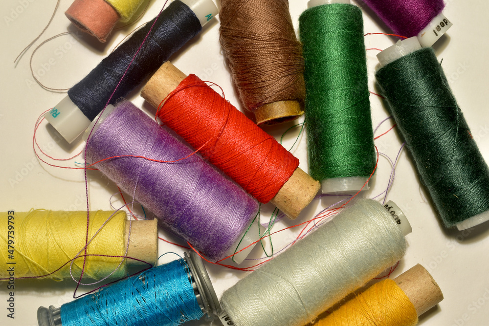 Spools of colored thread are on the table. Spools of colored thread are on the table.