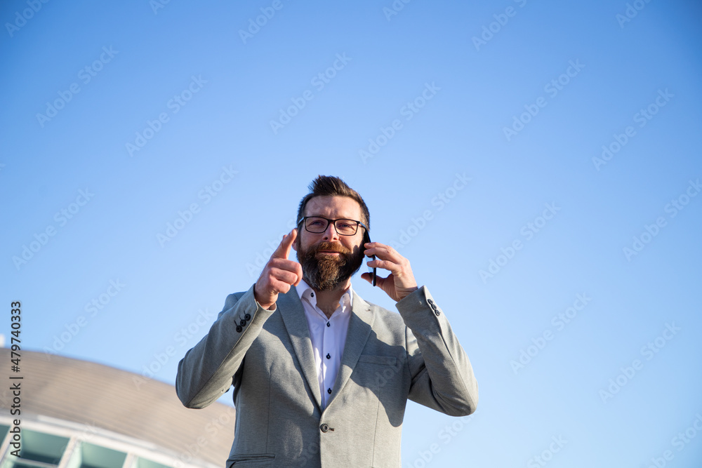 handsome businessman with phone in the city handsome businessman with phone in the city