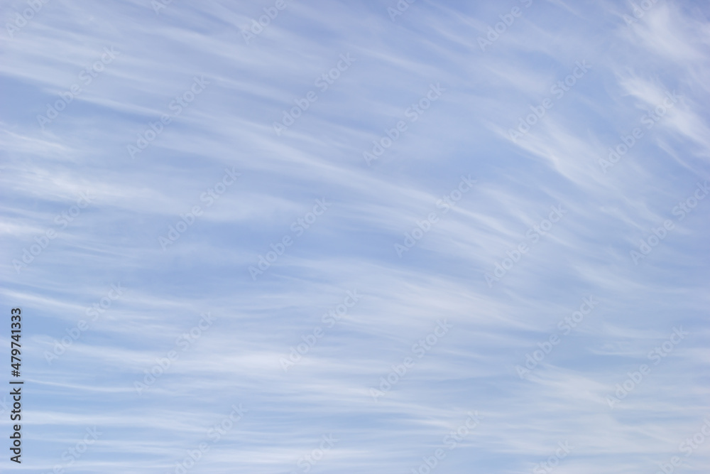 White cirrus clouds on the background blue sky. White cirrus clouds on the background blue sky.
