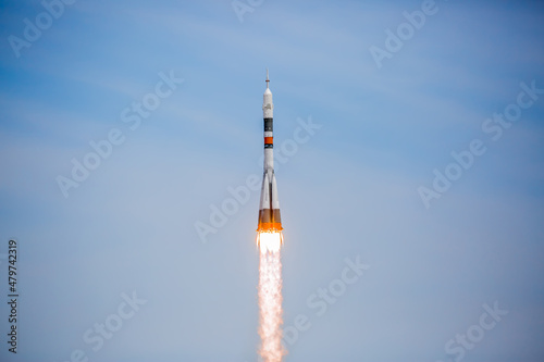 Take-off of a real launch vehicle from a spaceport. A rocket takes off into the sky against a background of clouds. Startup concept, power of science and technology.
