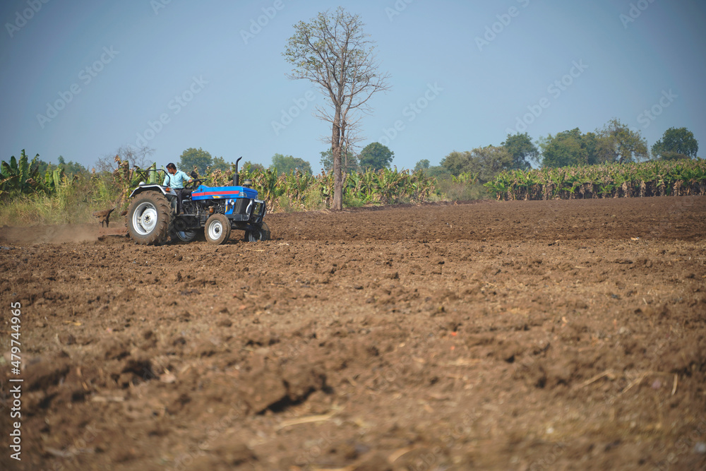 Indian farmer working with tractor in agriculture field. Indian farmer working with tractor in agriculture field.