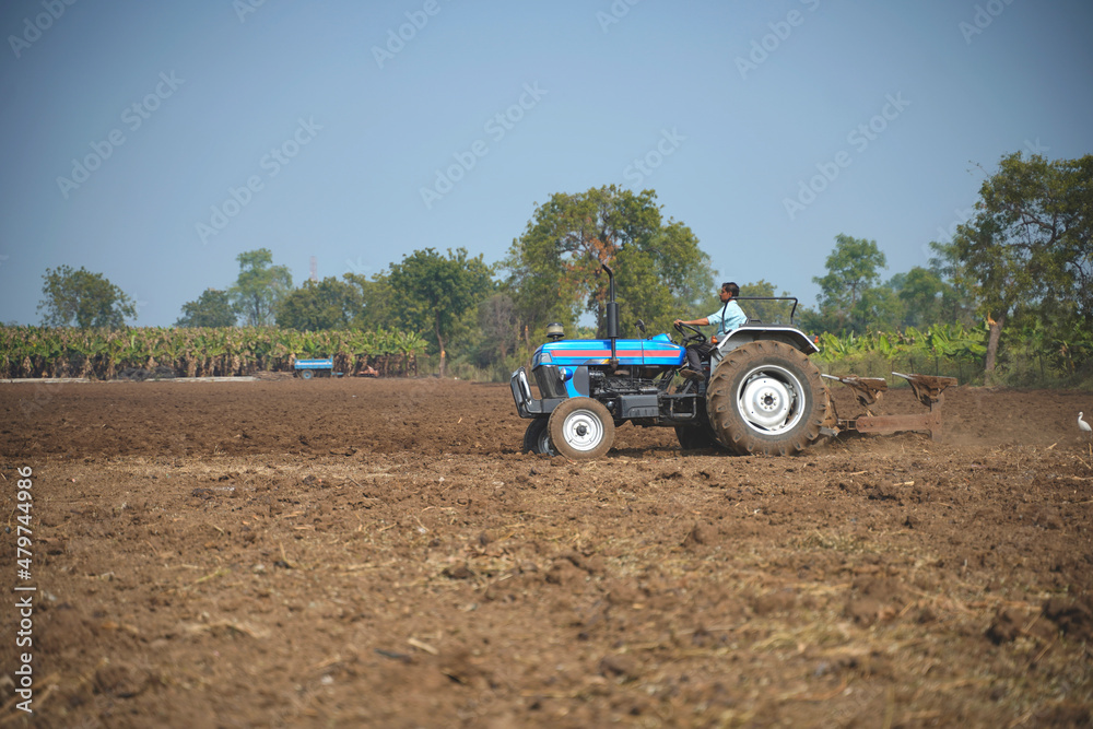 Indian farmer working with tractor in agriculture field. Indian farmer working with tractor in agriculture field.