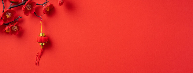 Chinese lunar new year background design concept with red plum blossom and festive decoration.