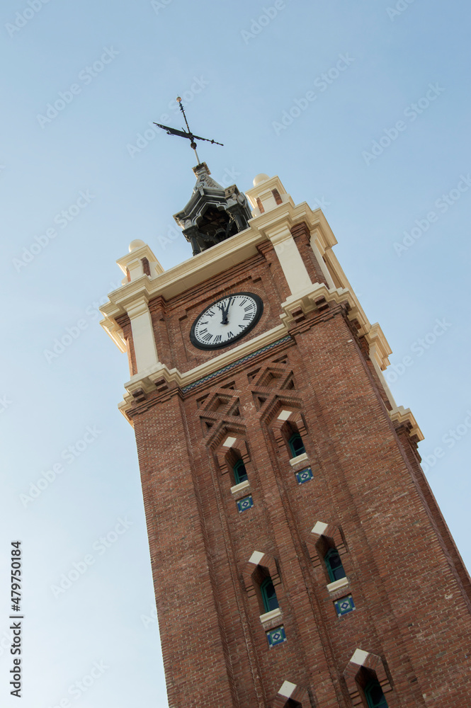Neomudejar style brick tower with clock and bell tower with bell in Madrid. Spain