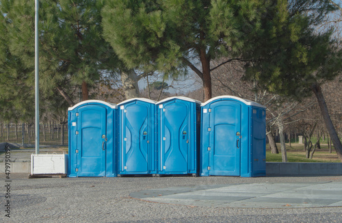 blue plastic cabins for public toilets in a park in Madrid. Spain