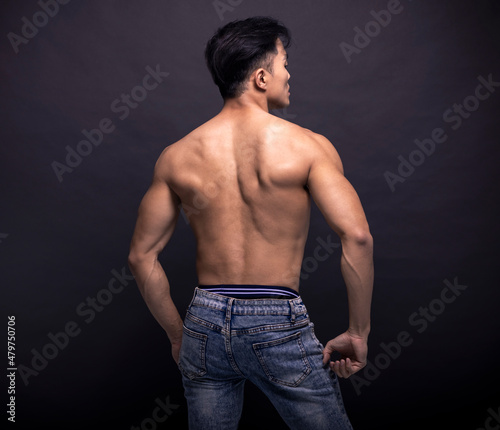 Rear view of muscular asian young man