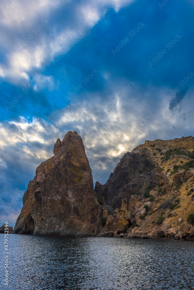 rocks of Cape Fiolent against the background of the evening sky with clouds