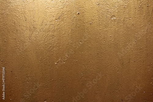 Old gold-colored weathered metal wall abstract background texture