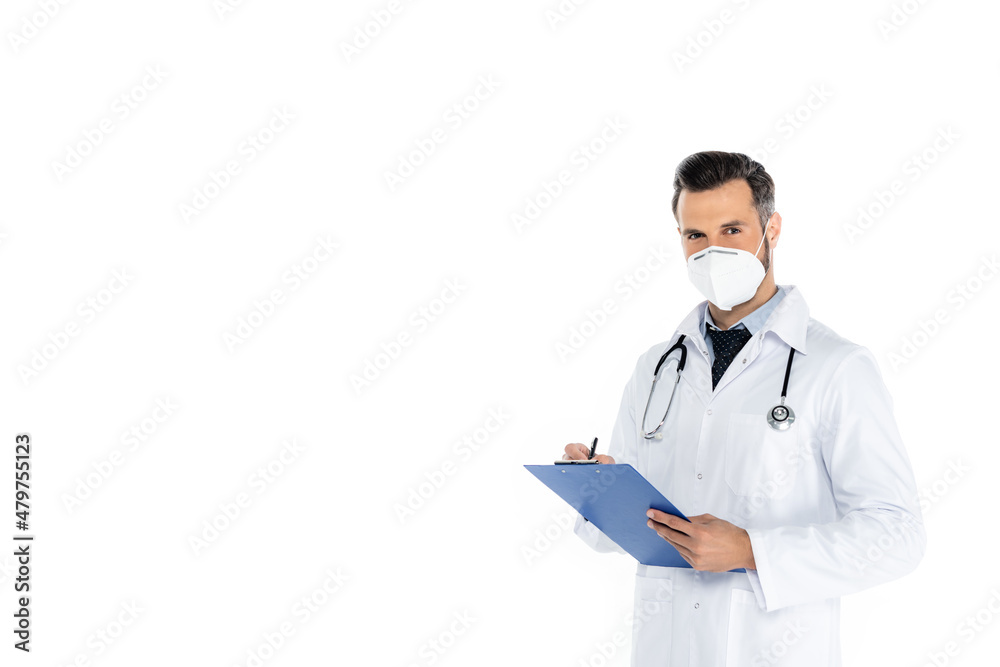doctor in white coat and medical mask writing on clipboard and looking at camera isolated on white. doctor in white coat and medical mask writing on clipboard and looking at camera isolated on white.