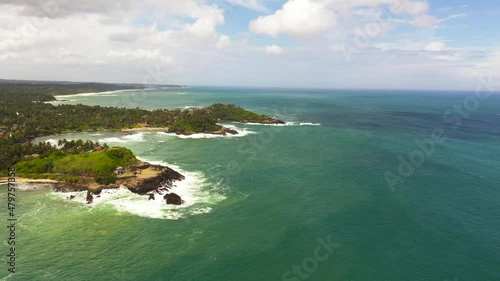 The coastline with hotels, palm trees and ocean surf. Travel concept. Sri Lanka. photo