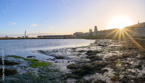 Hurst Castle English heritage military fort and Hurst Point Lighthouse just after sunrise with low tide and blue sky. Milford on Sea, Lymington, Hampshire, England photo