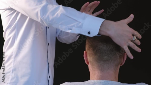 Biofield treatment and telepathy. A man diagnoses a patient using the biofield of his hands
