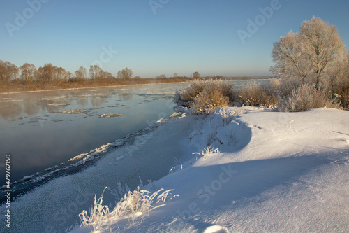 winter landscape. morning frost and sun. ice drift on the river. the branches of plants are covered with white frost