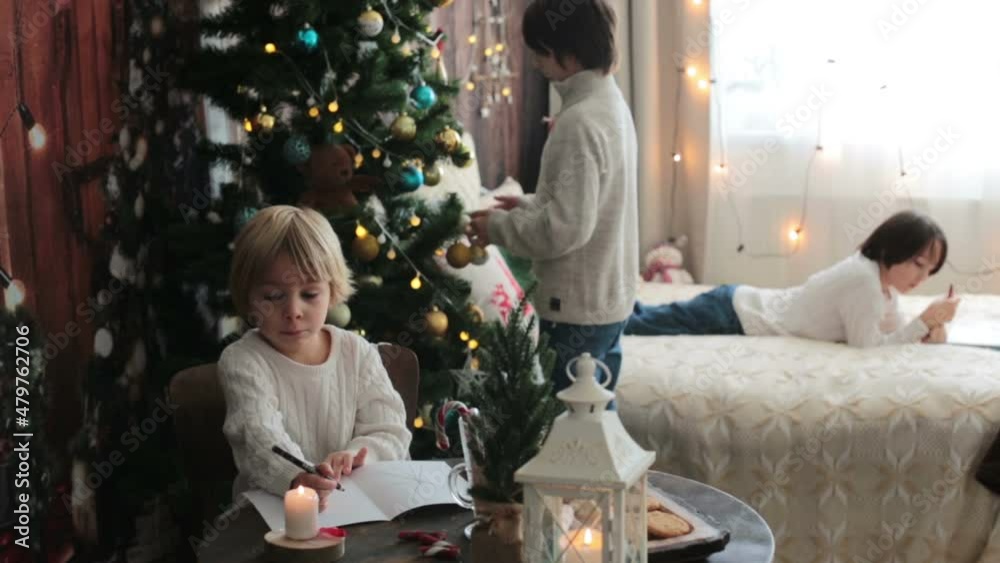Happy family, children, enjoying christmas together in cozy home, decorated with christmas decoration