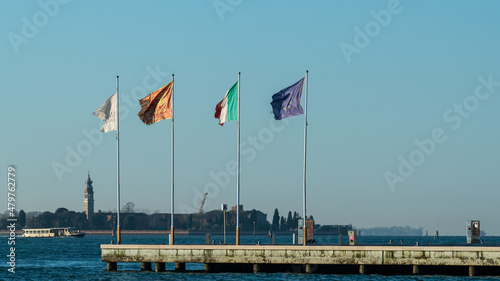 Flags on a pier in Venice on a sunny day in winter © Stefan