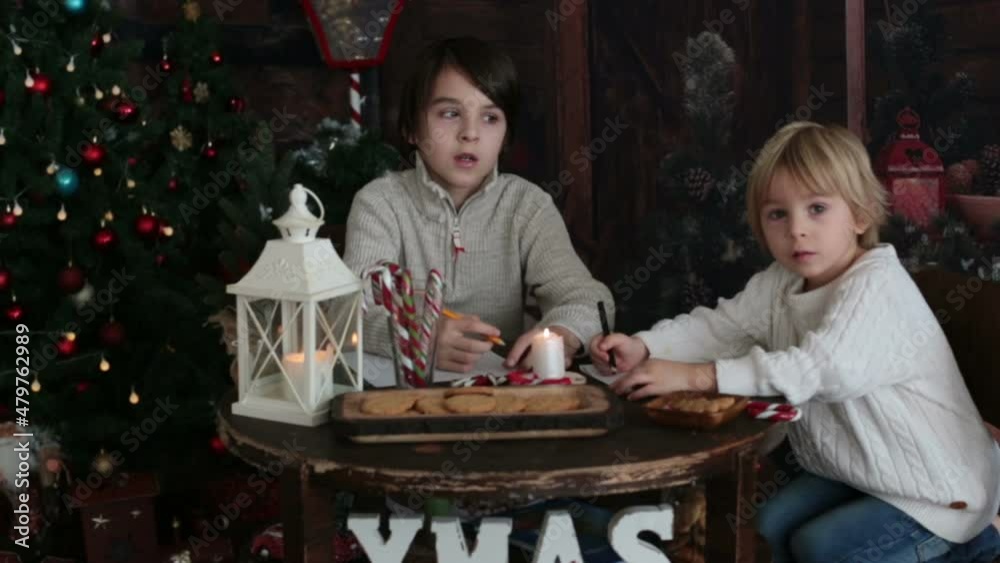 Happy family, children, enjoying christmas together in cozy home, decorated with christmas decoration