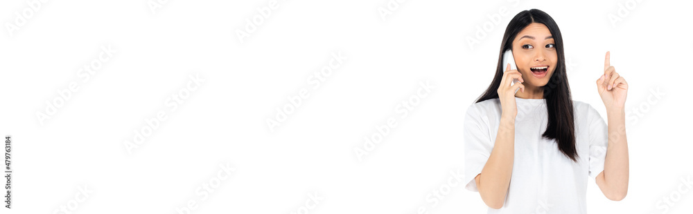 astonished asian woman showing idea gesture while talking on smartphone isolated on white, banner. astonished asian woman showing idea gesture while talking on smartphone isolated on white, banner.