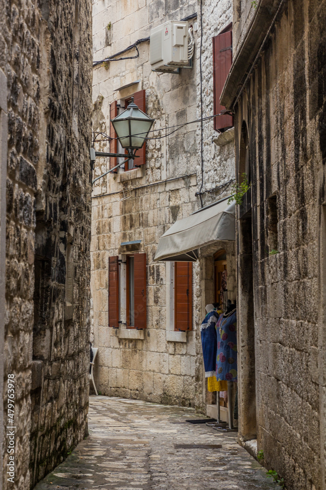 TROGIR, CROATIA - MAY 27, 2019: Narrow alley in the old town of Trogir, Croatia