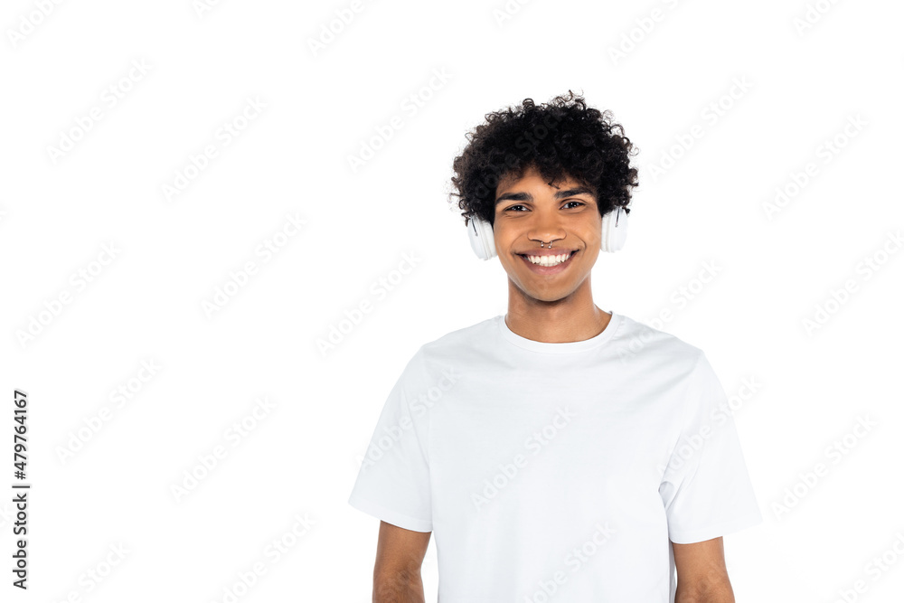 curly african american man in headphones smiling at camera isolated on white. curly african american man in headphones smiling at camera isolated on white.