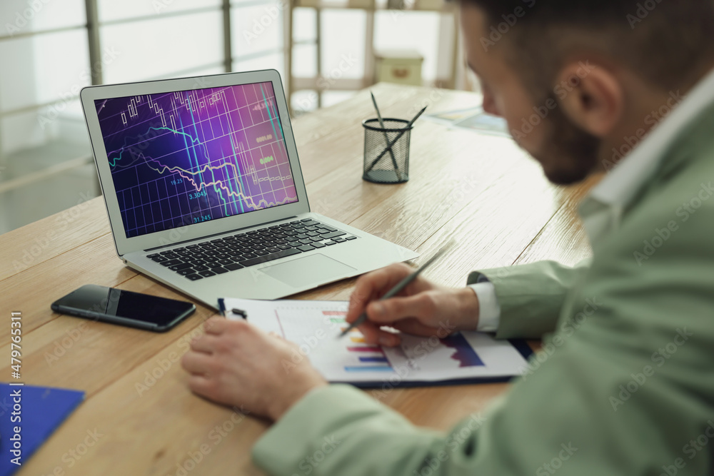 Broker working with laptop in office, closeup. Forex trading Broker working with laptop in office, closeup. Forex trading