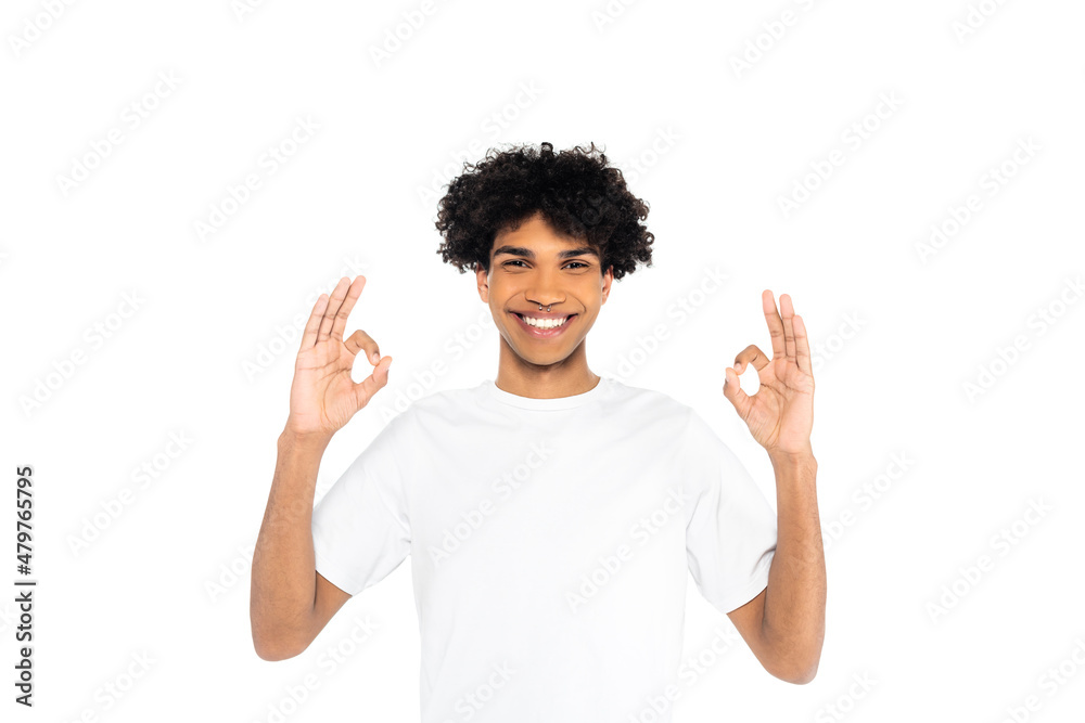 joyful african american man in t-shirt showing okay gesture isolated on white. joyful african american man in t-shirt showing okay gesture isolated on white.