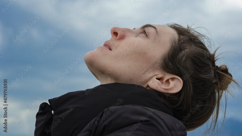 portrait of a young woman looking at the sky portrait of a young woman looking at the sky