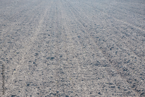 Photo of a plowed field. The texture of black soil after machining. Agriculture. Soil preparation for sowing