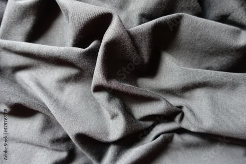Unprinted black cotton jersey fabric in soft folds