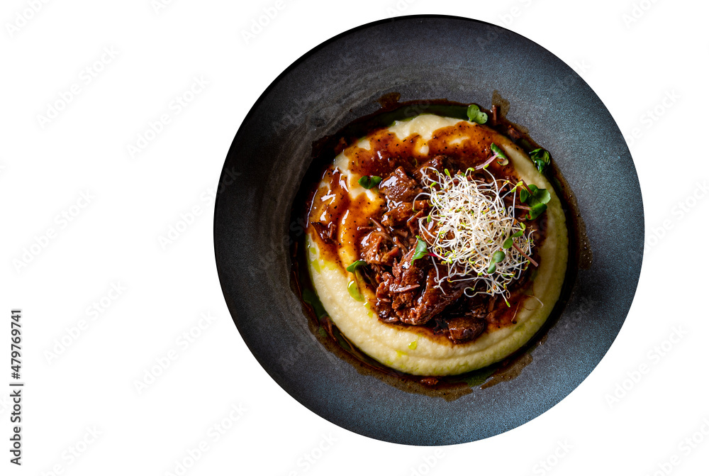 Stewed veal cheeks with mashed potatoes on plate isolated on white background Stewed veal cheeks with mashed potatoes on plate isolated on white background