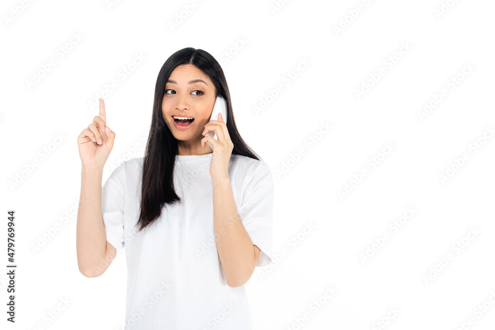 amazed asian woman showing idea gesture while talking on mobile phone isolated on white. amazed asian woman showing idea gesture while talking on mobile phone isolated on white.