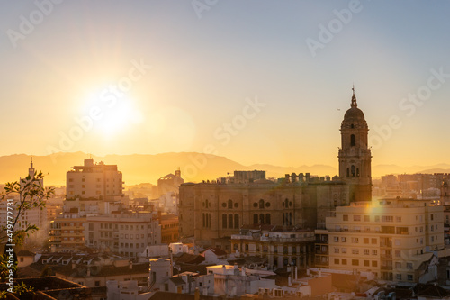 Sunset from the walls of the Alcazaba of the city of Malaga and in the background the Cathedral of the Incarnation of Malaga, Andalusia. Spain. Medieval fortress in arabic style © unai