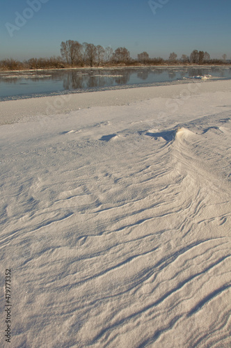 winter landscape. morning frost and sun. ice drift on the river. the branches of plants are covered with white frost