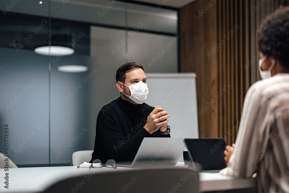 Serious caucasian man wearing a mask, fixing the problem in the company. Serious caucasian man wearing a mask, fixing the problem in the company.